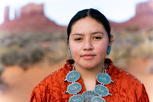 Young Native youth wearing traditional clothing and regalia outs