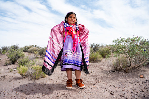 Young Native girl wearing traditional regalia outside