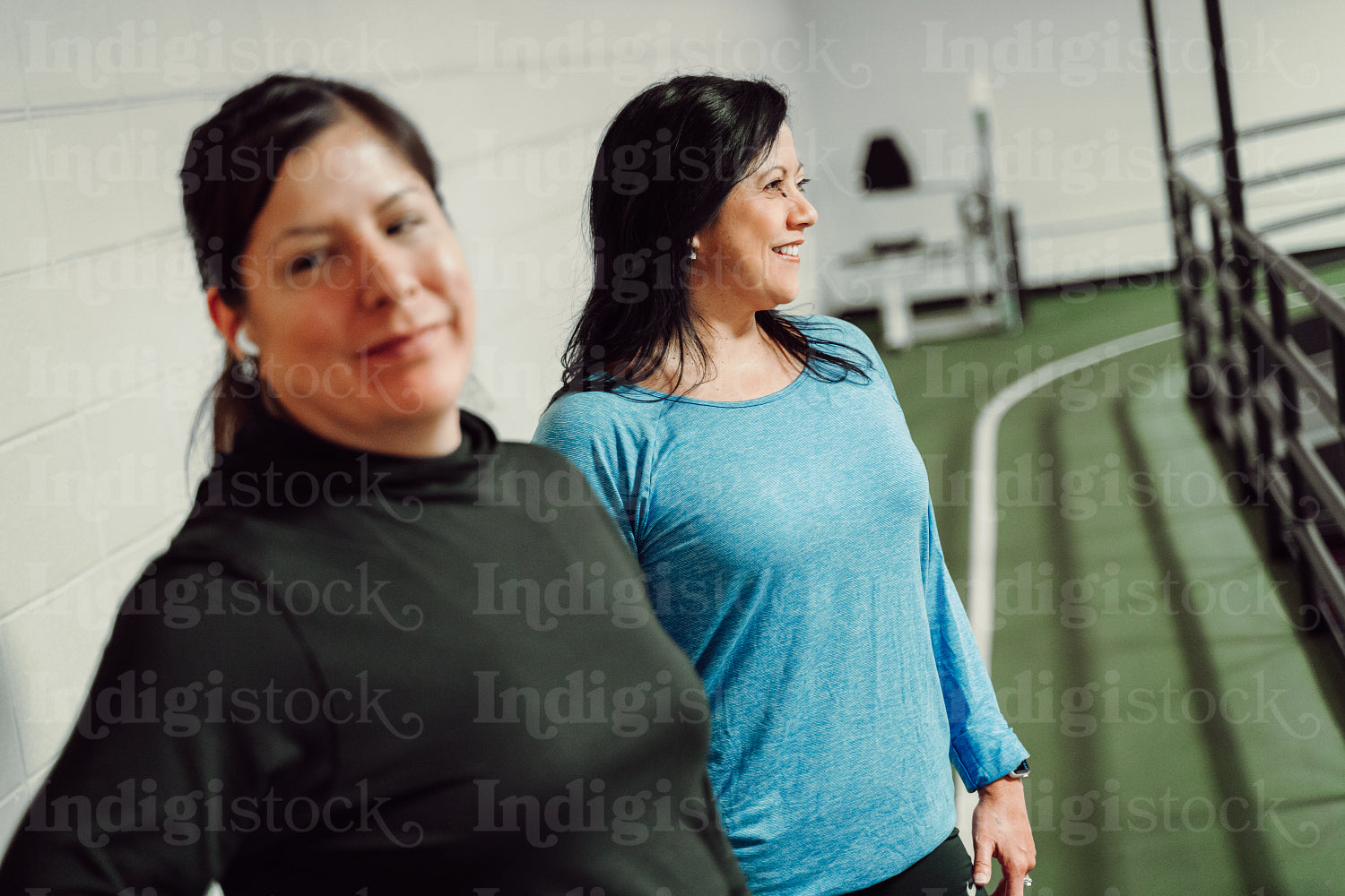 Indigenous women walking on a track