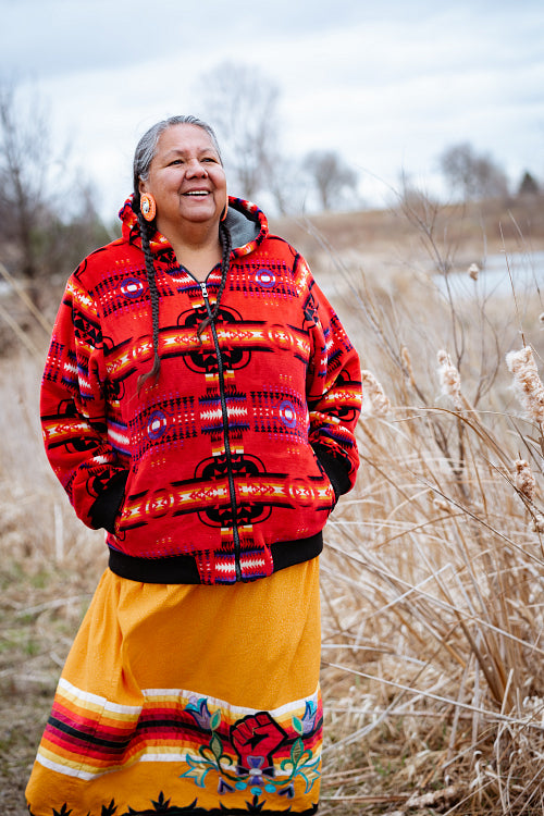 Indigenous elder woman on lake shore