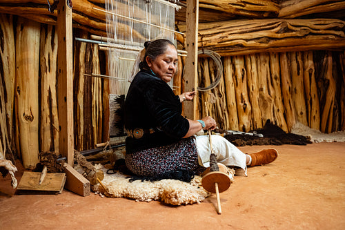 Indigenous woman weaving a traditional pattern in Hogan Earthlod