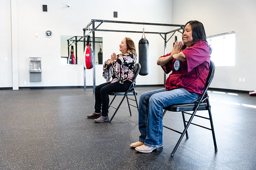 Native woman learning from an instructor