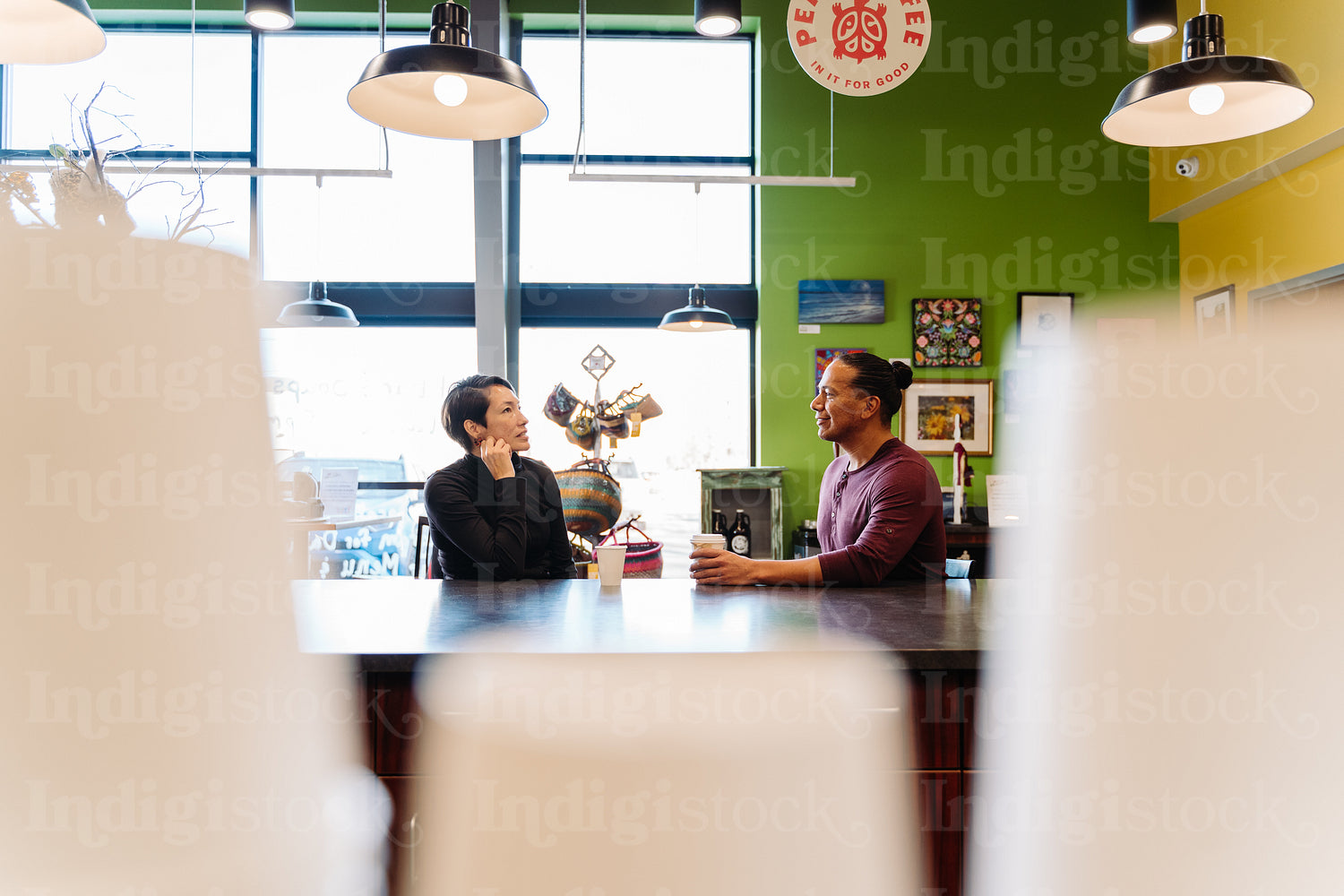 Indigenous couple talking over a cup of coffee