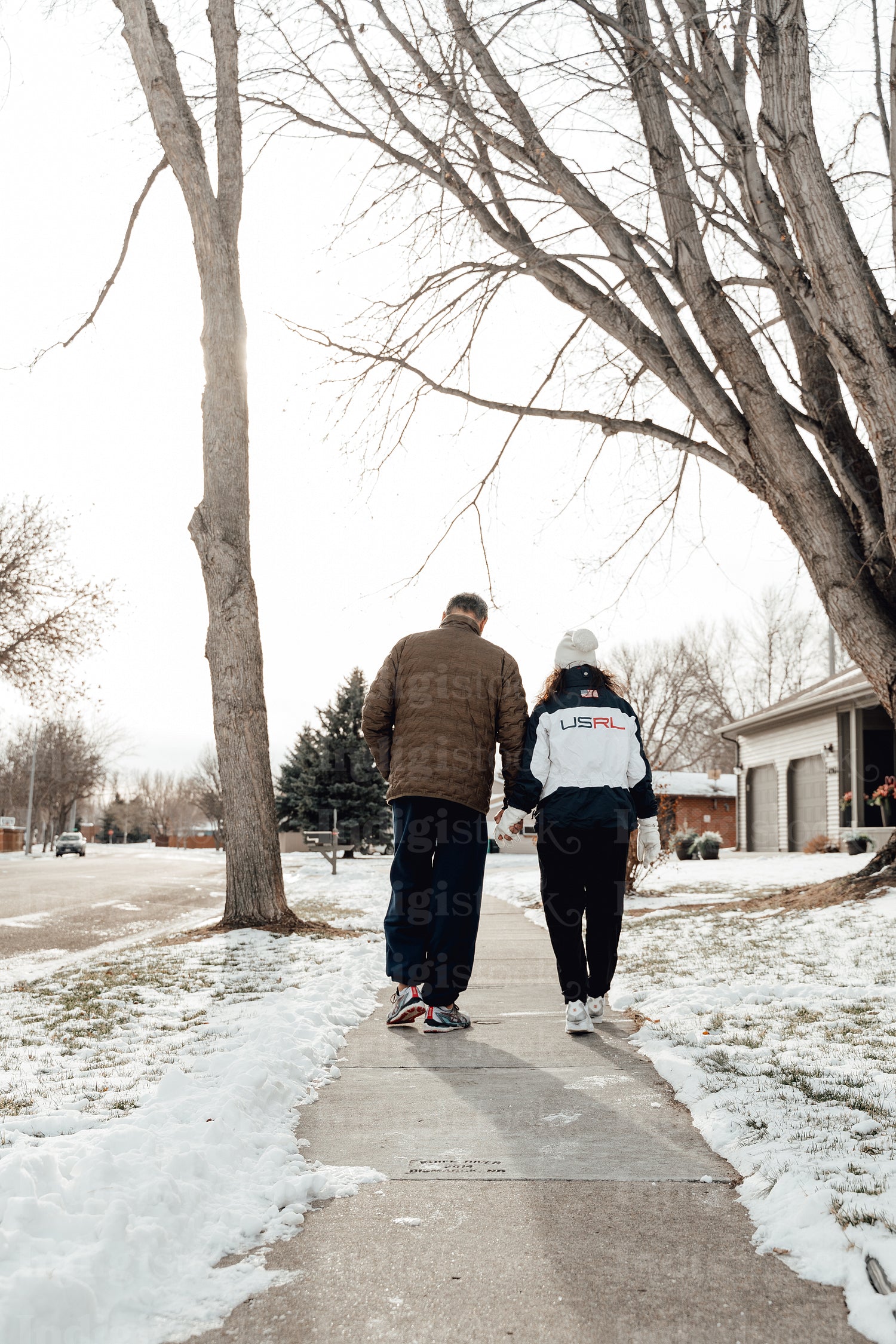 Indigenous couple walking through snow