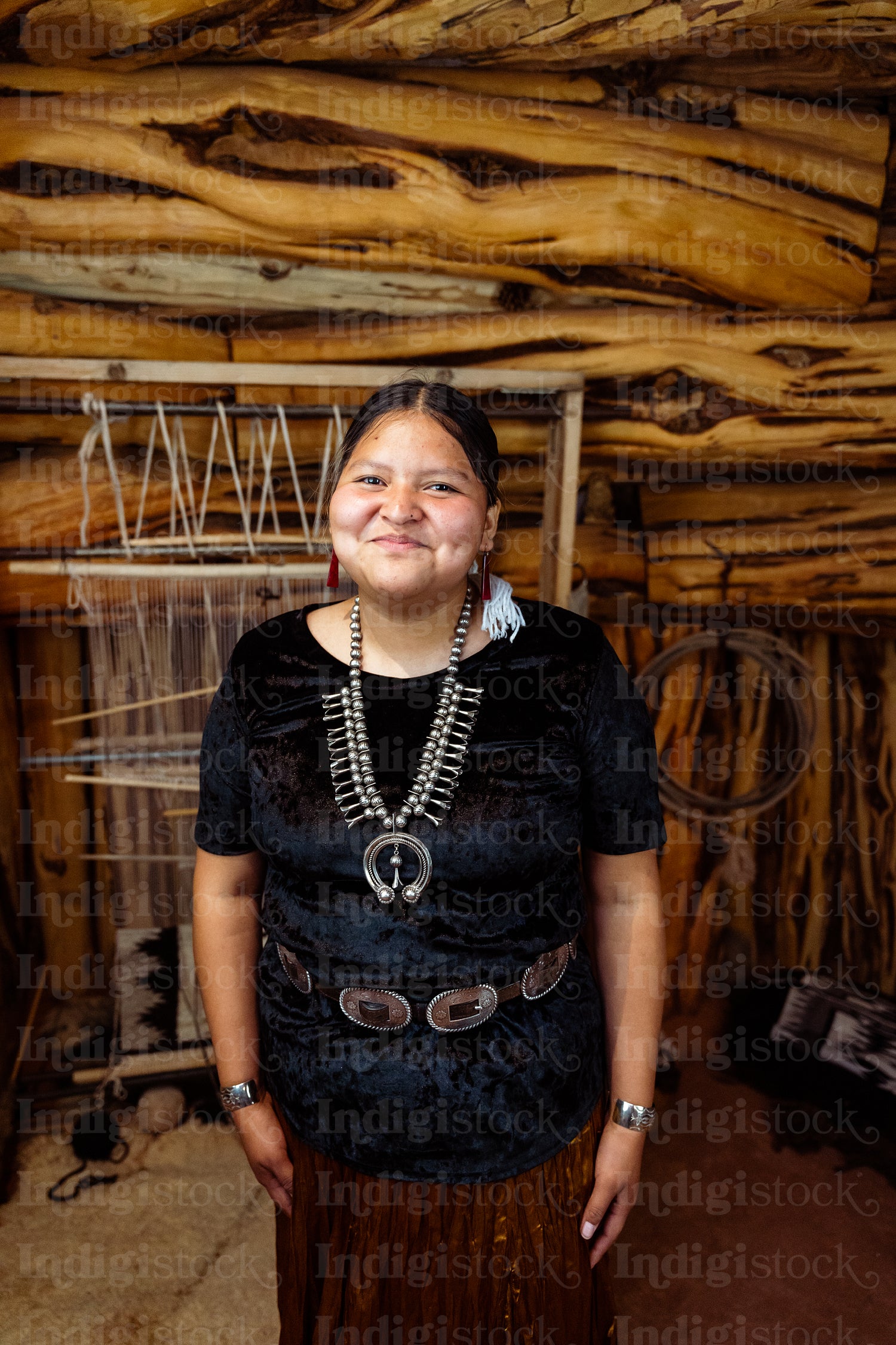 A Native American Navajo woman standing inside a Hogan Earthlodg