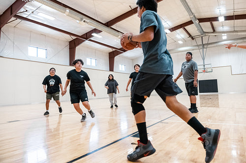 A Native family playing a game of basketball