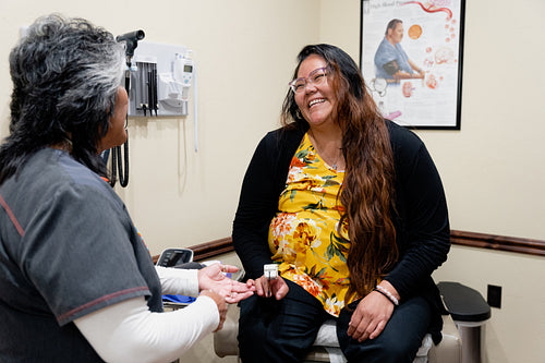 A native woman getting checked by an indigenous nurse