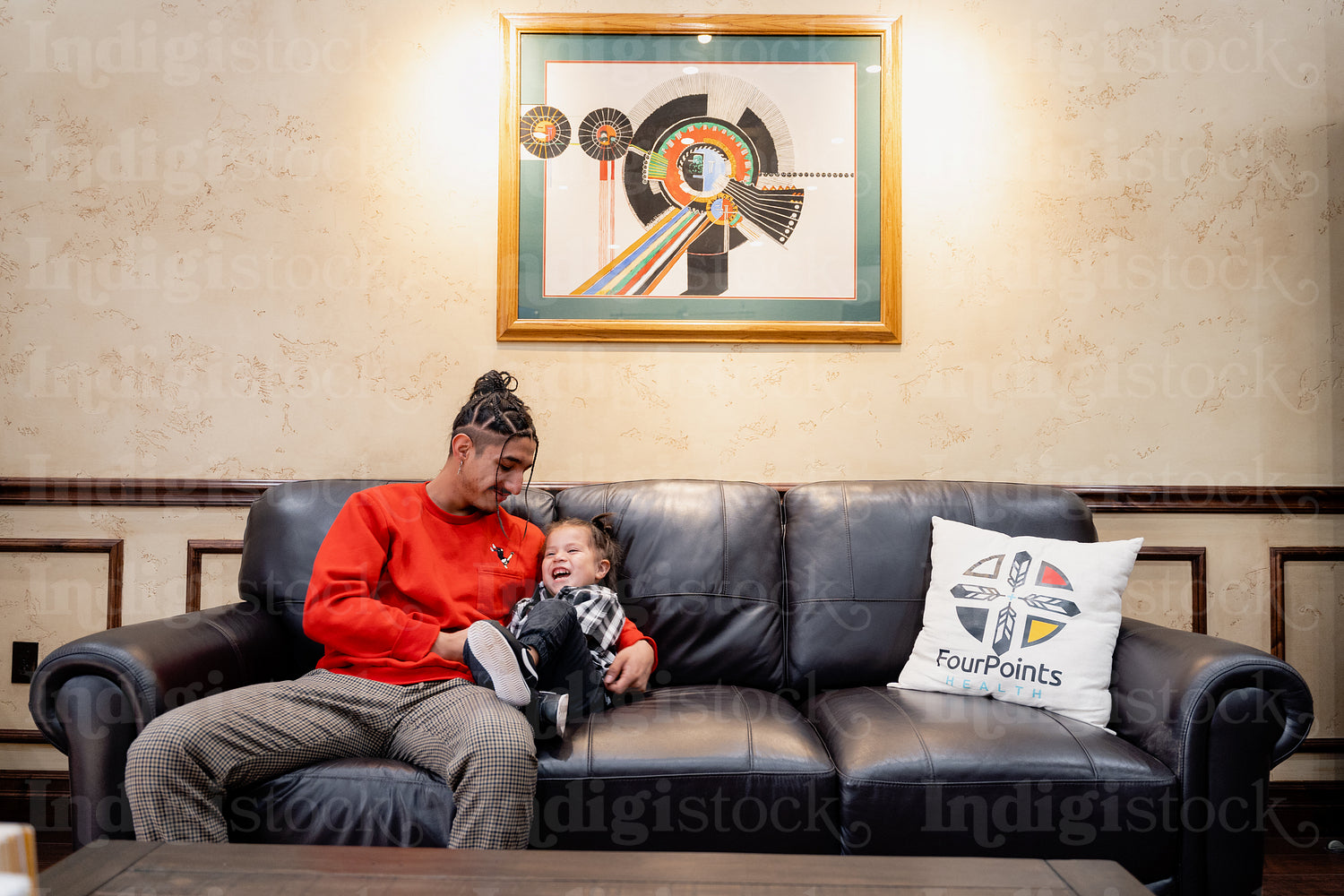 A Native father with his child waiting at a health clinic 