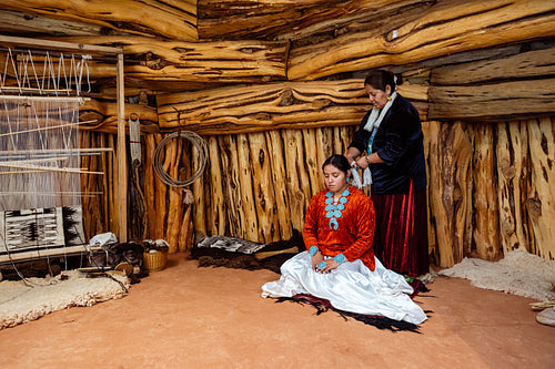 Native Women wearing traditional regalia in Earth Lodge