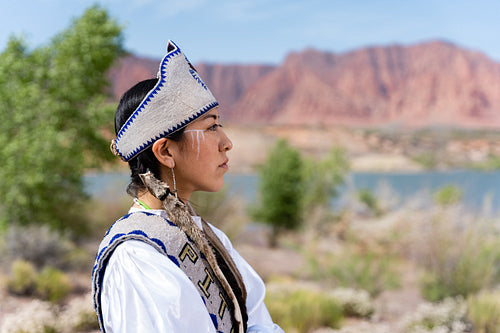 A young Native woman in traditional clothing and regalia