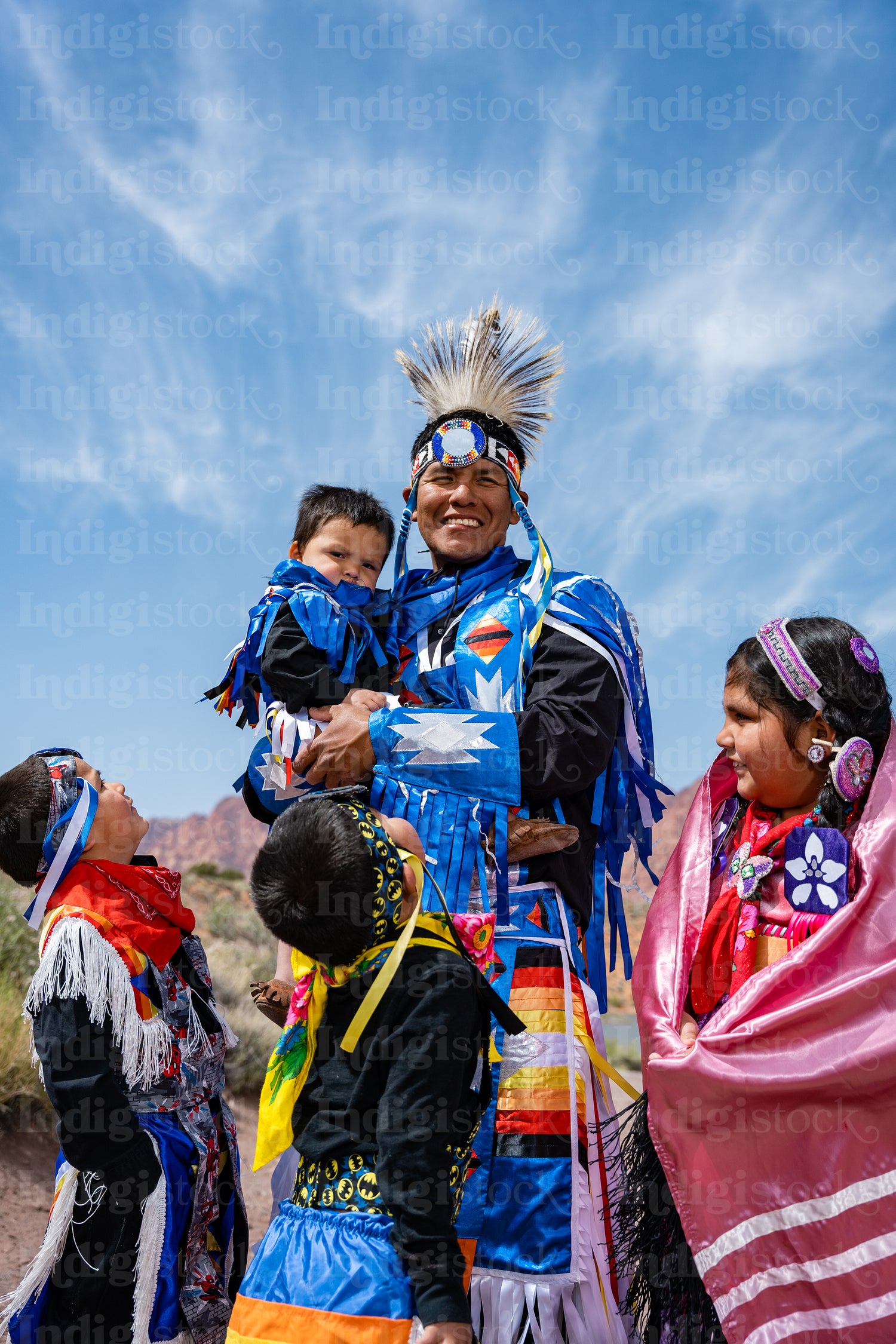 Happy Indigenous family in tradtional regalia outside