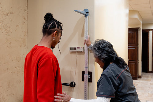 An Indigenous man being check by a native health care nurse