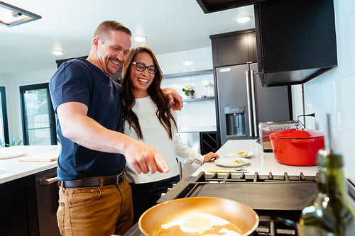 A couple cooking a meal together