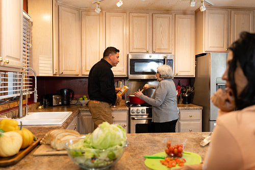 Indigenous mother and son cooking