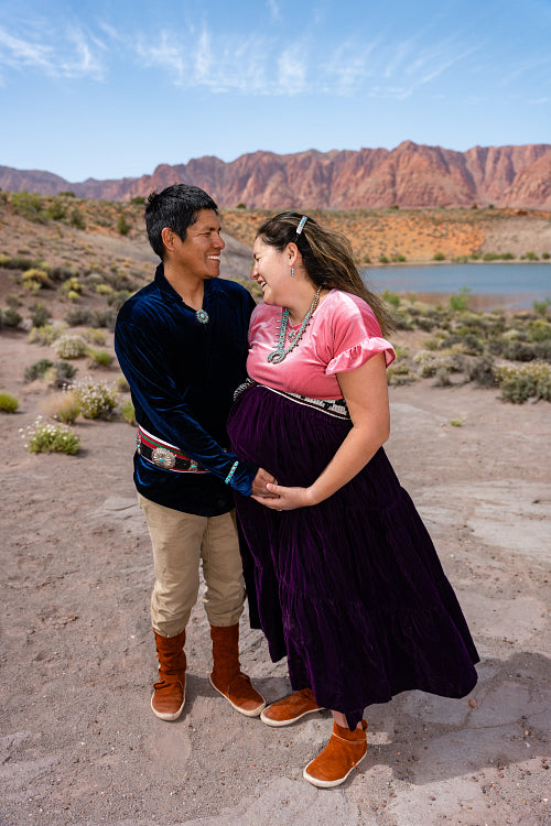 Expecting Native couple wearing traditional regalia clothing out