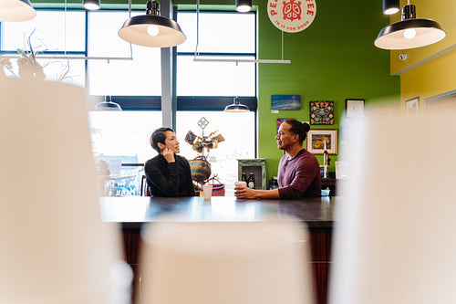 Indigenous couple talking over a cup of coffee