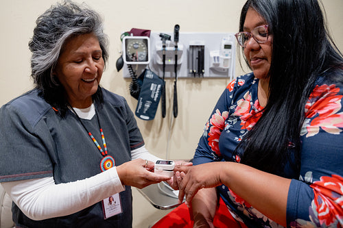 A native woman getting checked by an indigenous nurse