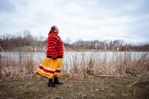 Indigenous elder woman on lake shore