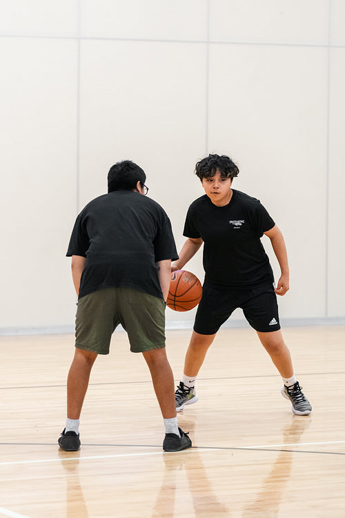 Native youth playing basketball