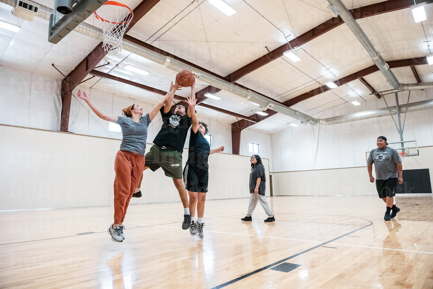 A Native family playing a game of basketball 