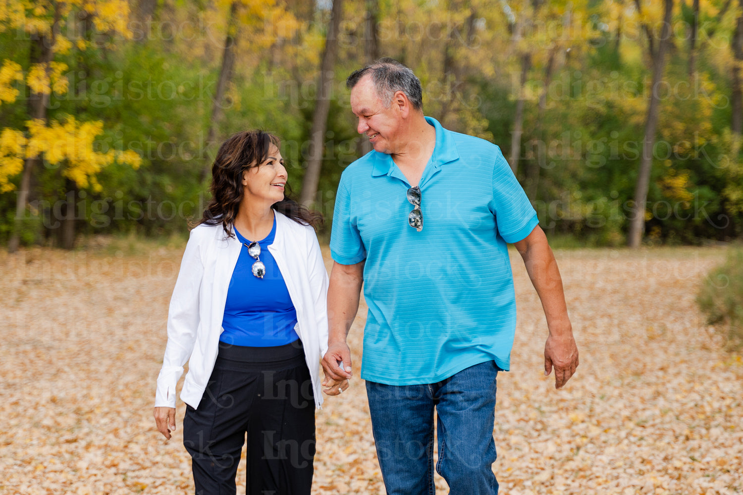 Middle aged Native couple taking a walk through the woods