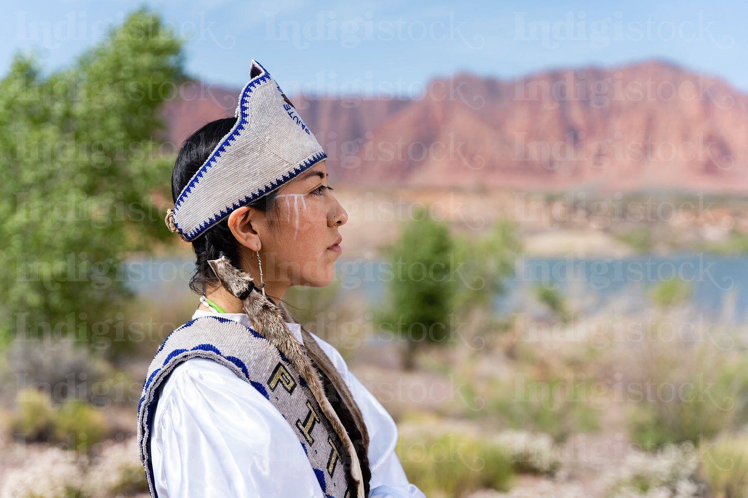 A young Native woman in traditional clothing and regalia 