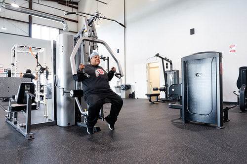 A Indigenous woman working out in a gym