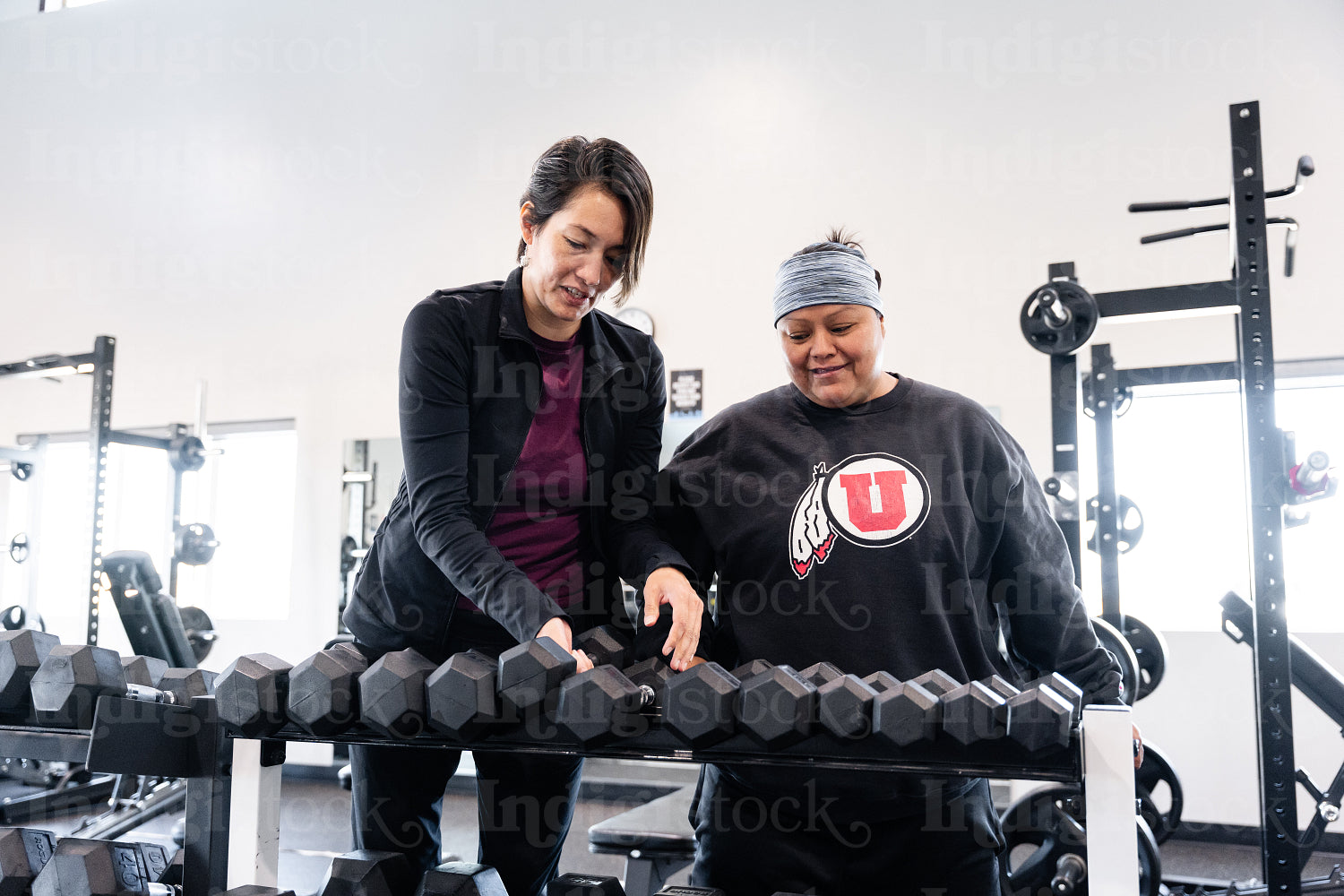 A Indigenous woman working out in a gym