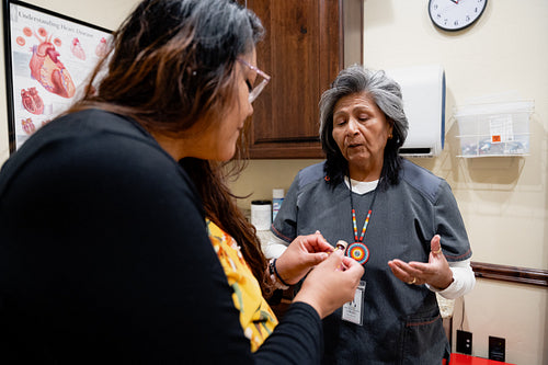 A native women getting checked by an indigenous nurse