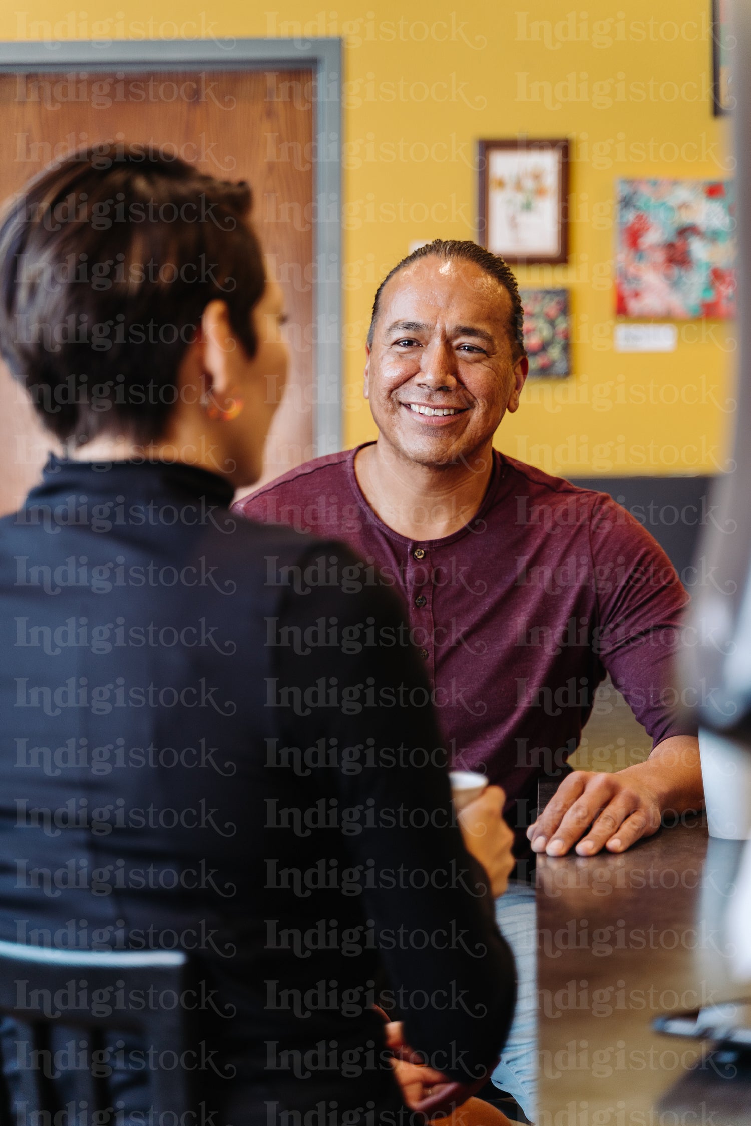 Indigenous couple talking over a cup of coffee