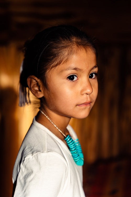 Native American children wearing traditional regalia