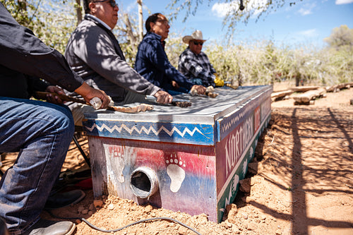 Native men singing songs and playing instruments