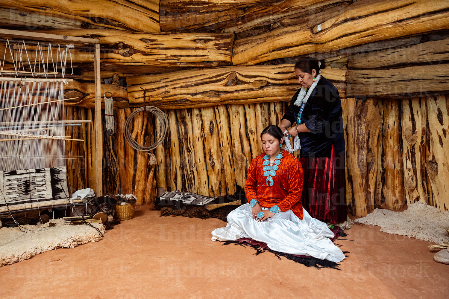 Native Women wearing traditional regalia in Earth Lodge