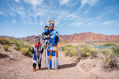 Happy Indigenous family in tradtional regalia outside