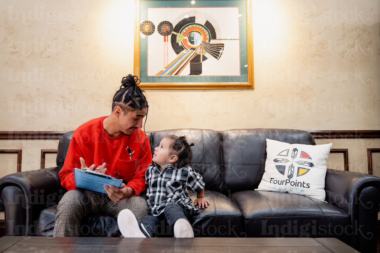 A Native father with his child waiting at a health clinic 