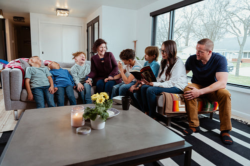 A family of Native Peoples reading a book together