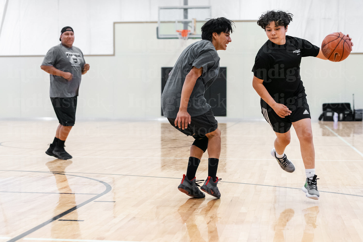 A Native family playing a game of basketball 