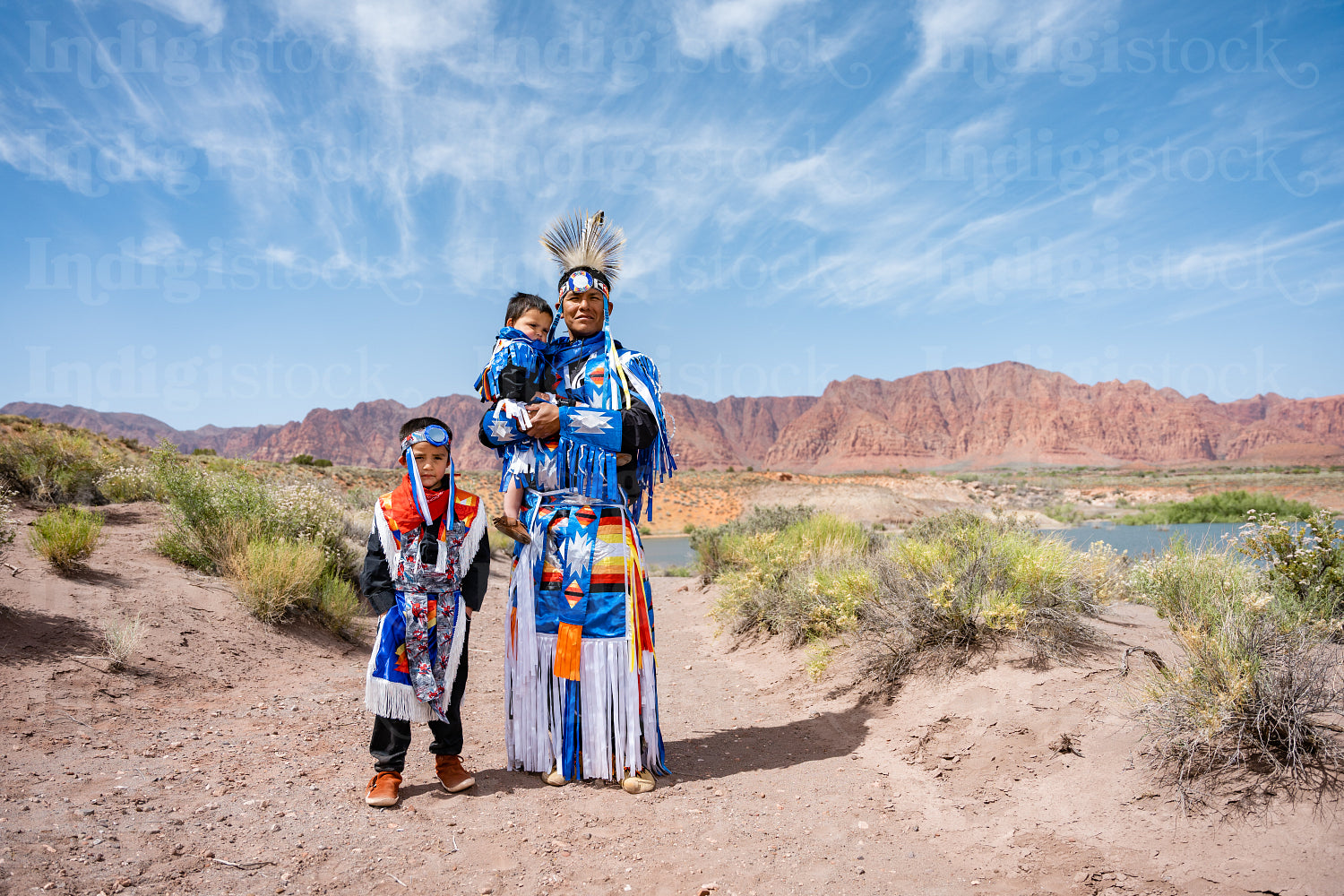 Happy Indigenous family in tradtional regalia outside