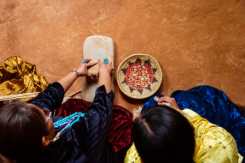 Native Women grinding corn