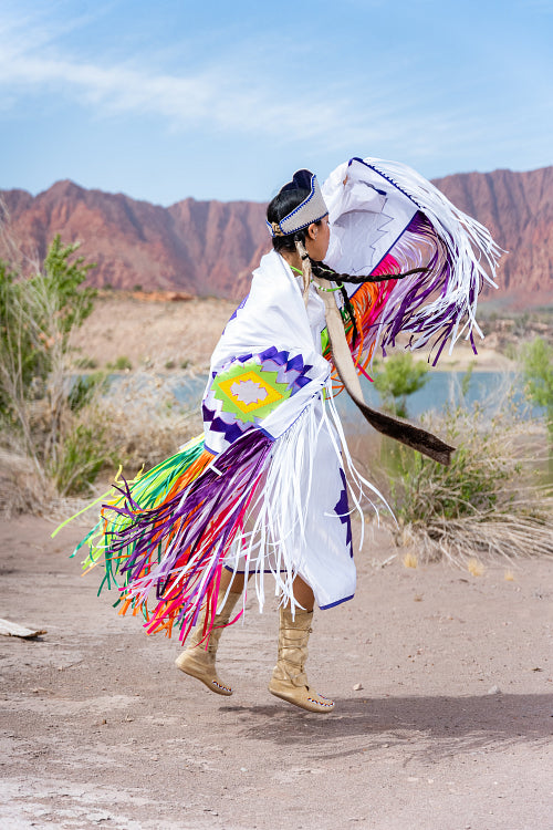 A young Native woman in traditional clothing and regalia