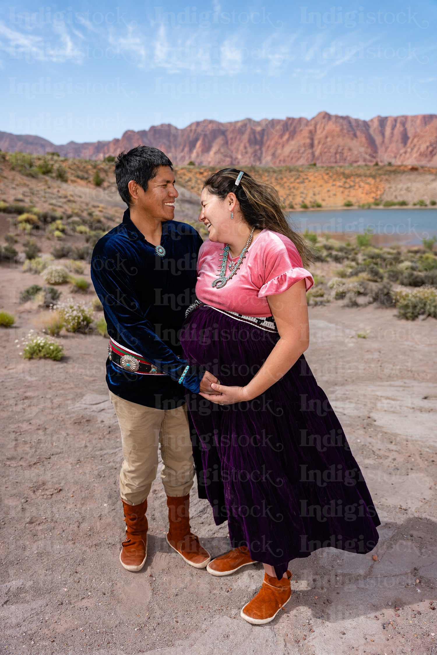 Expecting Native couple wearing traditional regalia clothing out