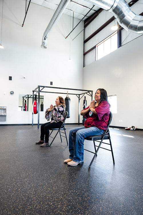 Native woman learning from an instructor