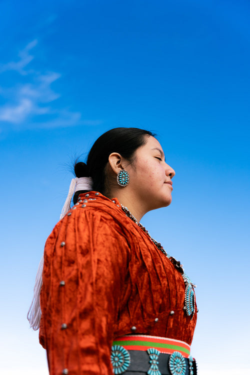 Young Native youth wearing traditional clothing and regalia outs