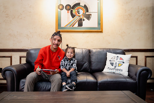 A Native father with his child waiting at a health clinic