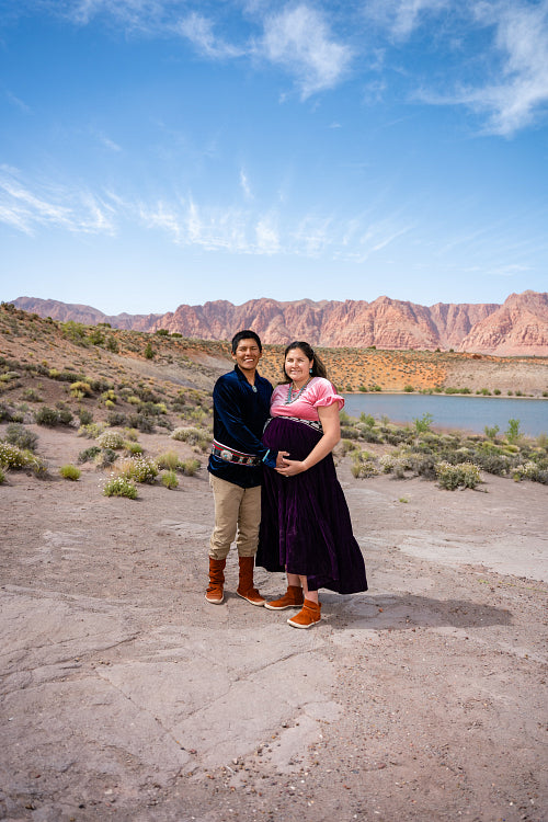 Expecting Native couple wearing traditional regalia clothing out