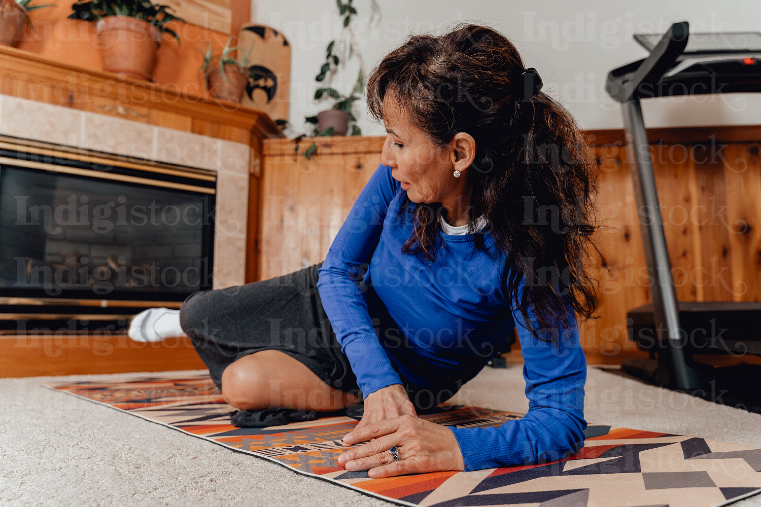 Indigenous woman working out in home gym