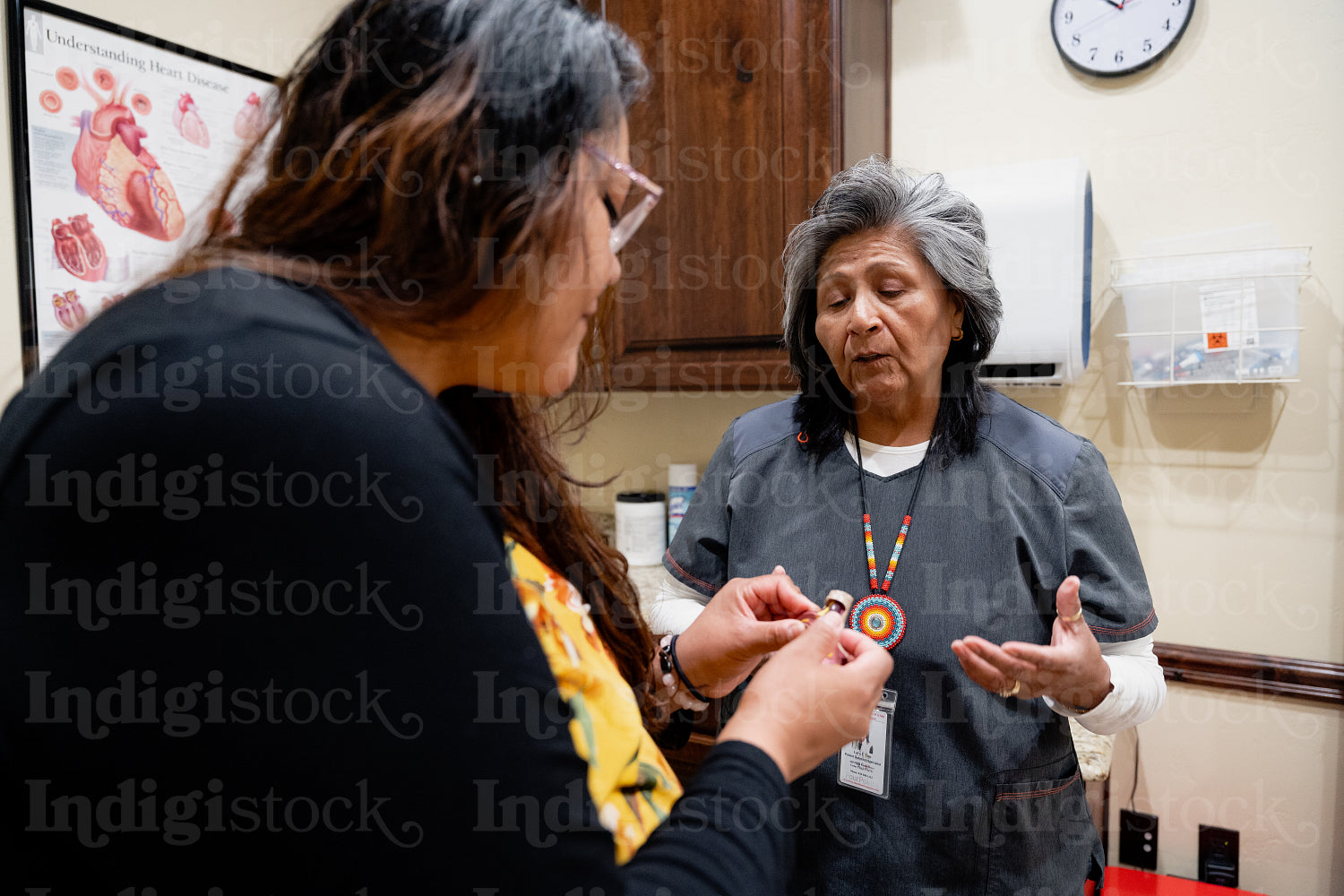 A native women getting checked by an indigenous nurse 