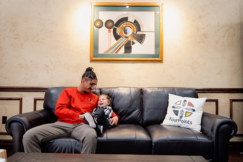 A Native father with his child waiting at a health clinic