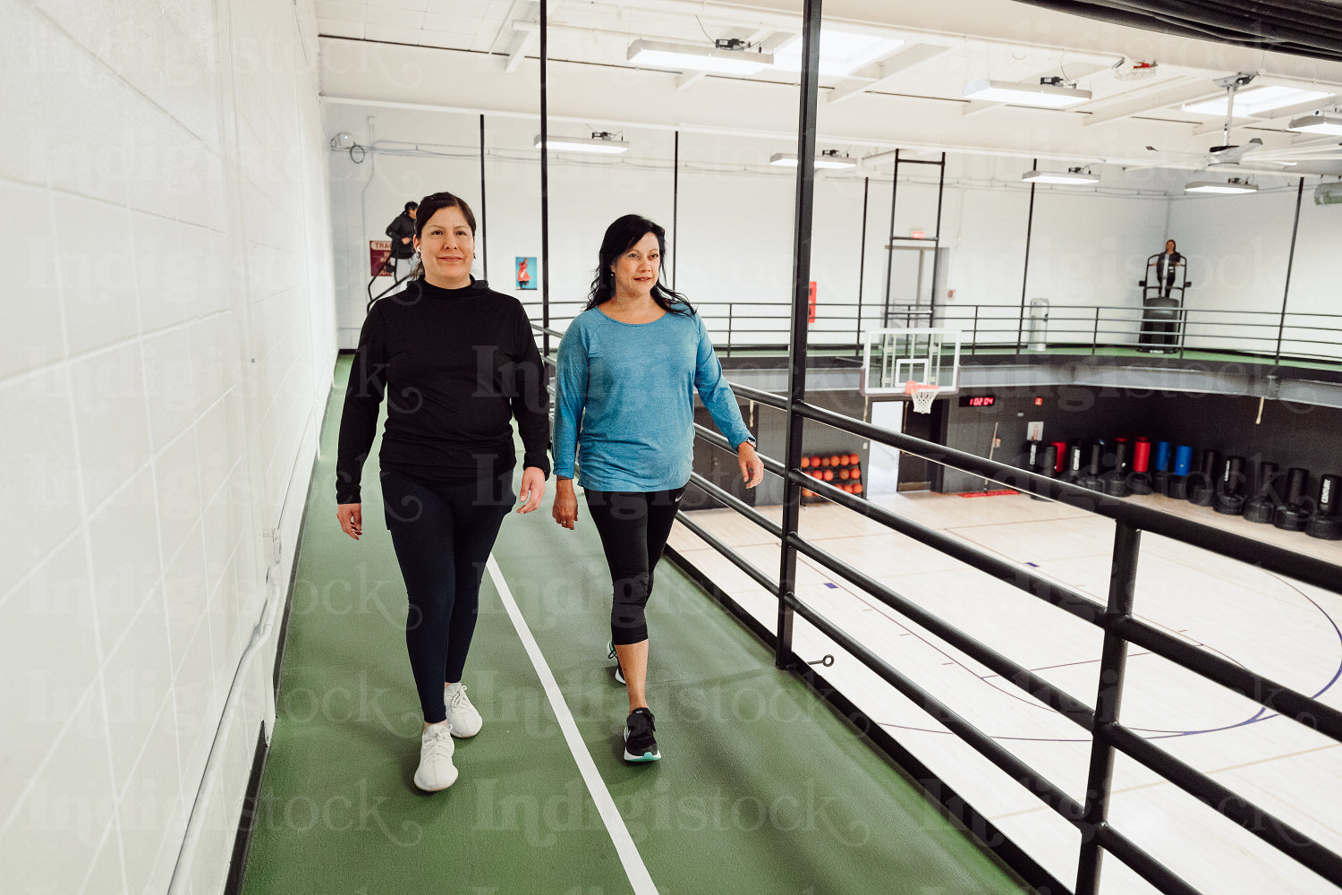 Indigenous women walking on a track