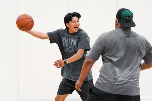 Native youth playing basketball